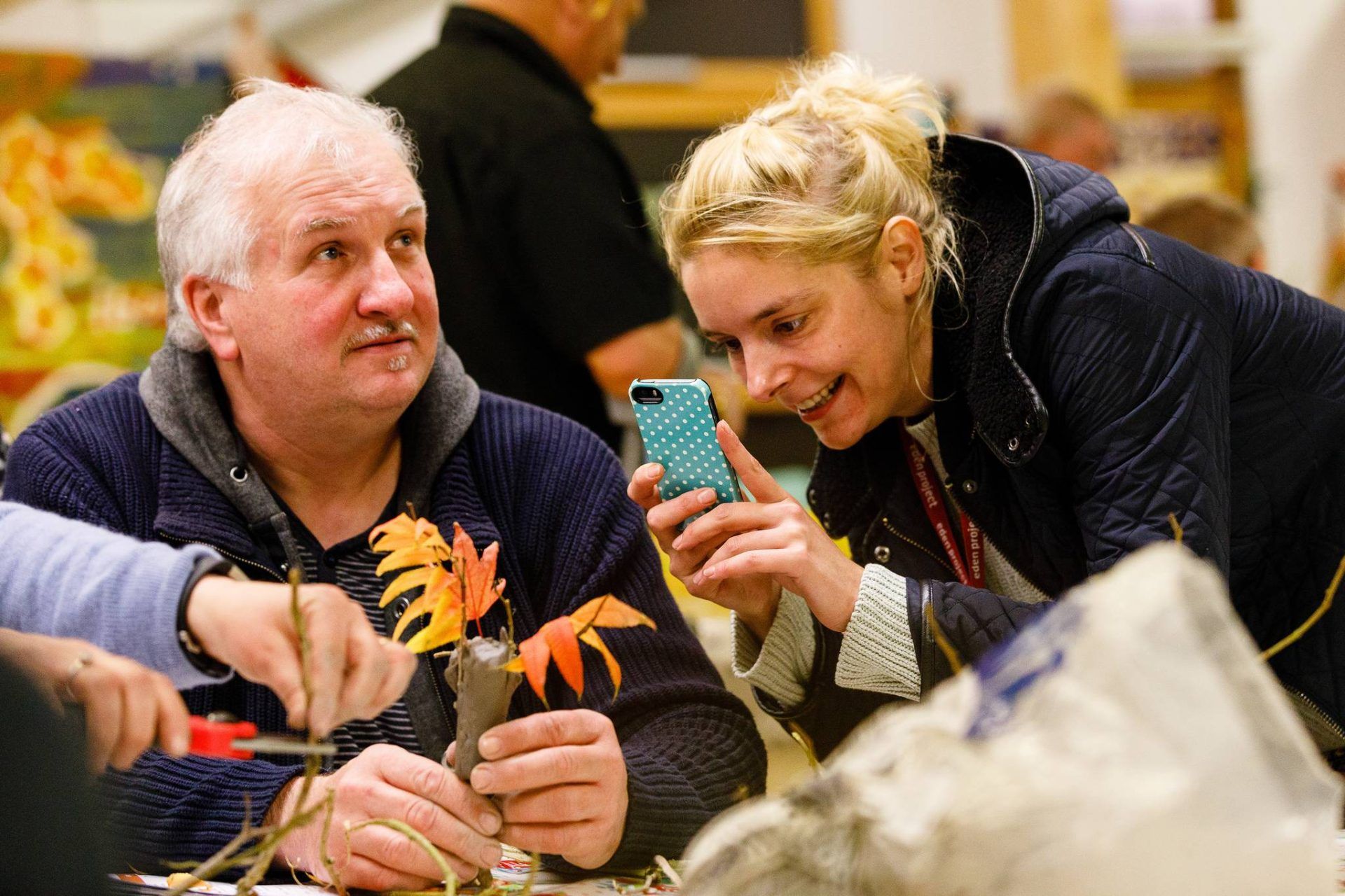 Person taking a photograph of a craft project