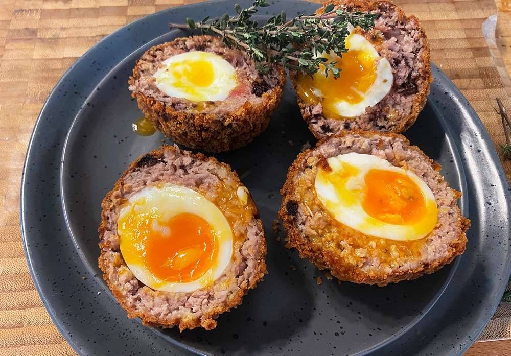 A Plate of scotch eggs, oozing with delicious yolk