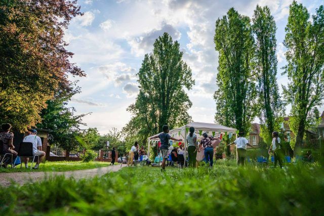 A Big Lunch in a park - marquees and people are visible in the background