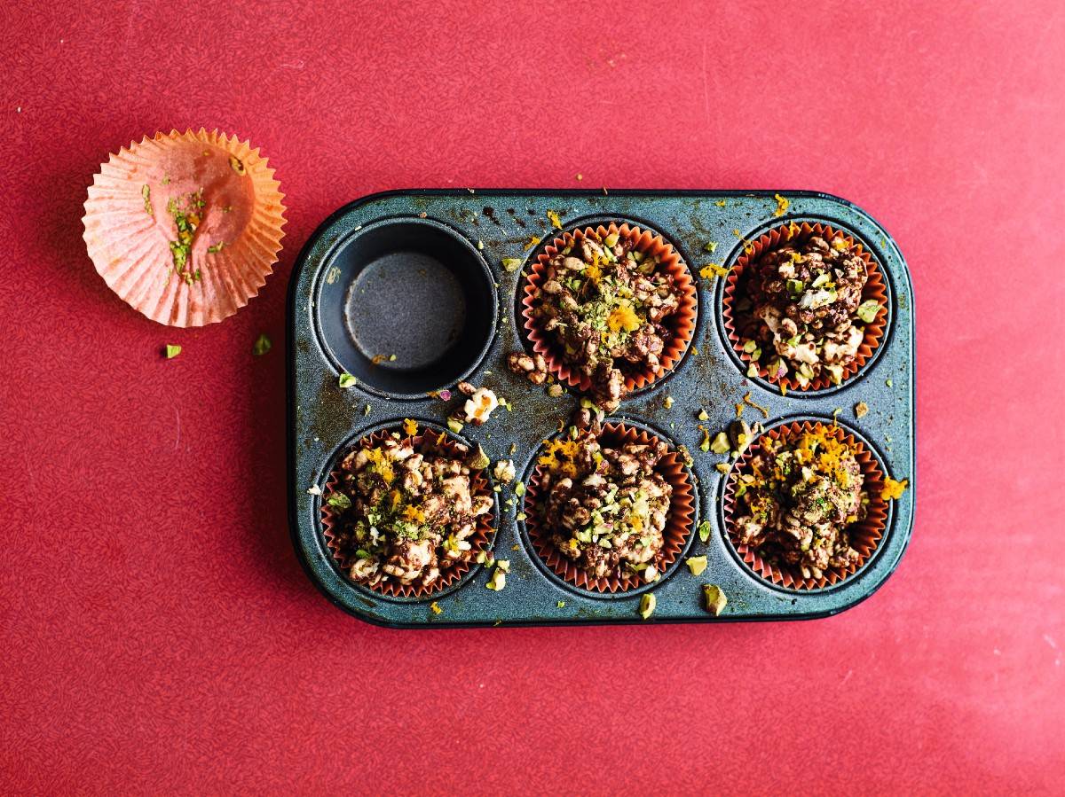 Chocolate orange popcorn in muffin cases in tray, with one empty muffin case