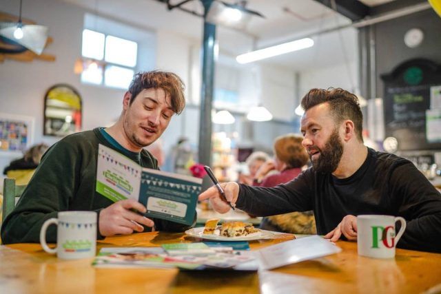 One of our Community Network Developers, Paul, having a conversation with another man at an inside event in Manchester.