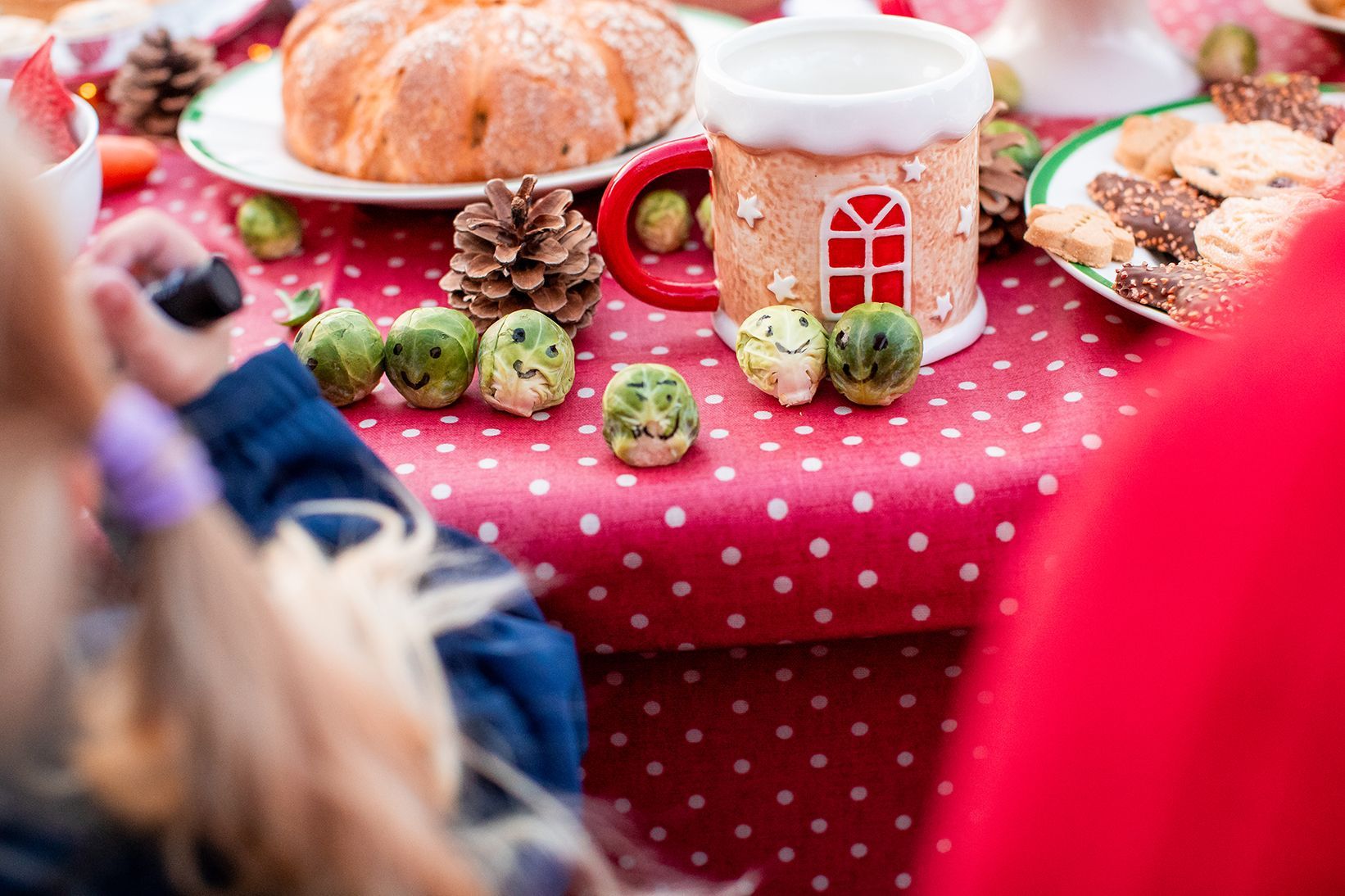 A bunch of sprouts on a table with smiley faces drawn on.