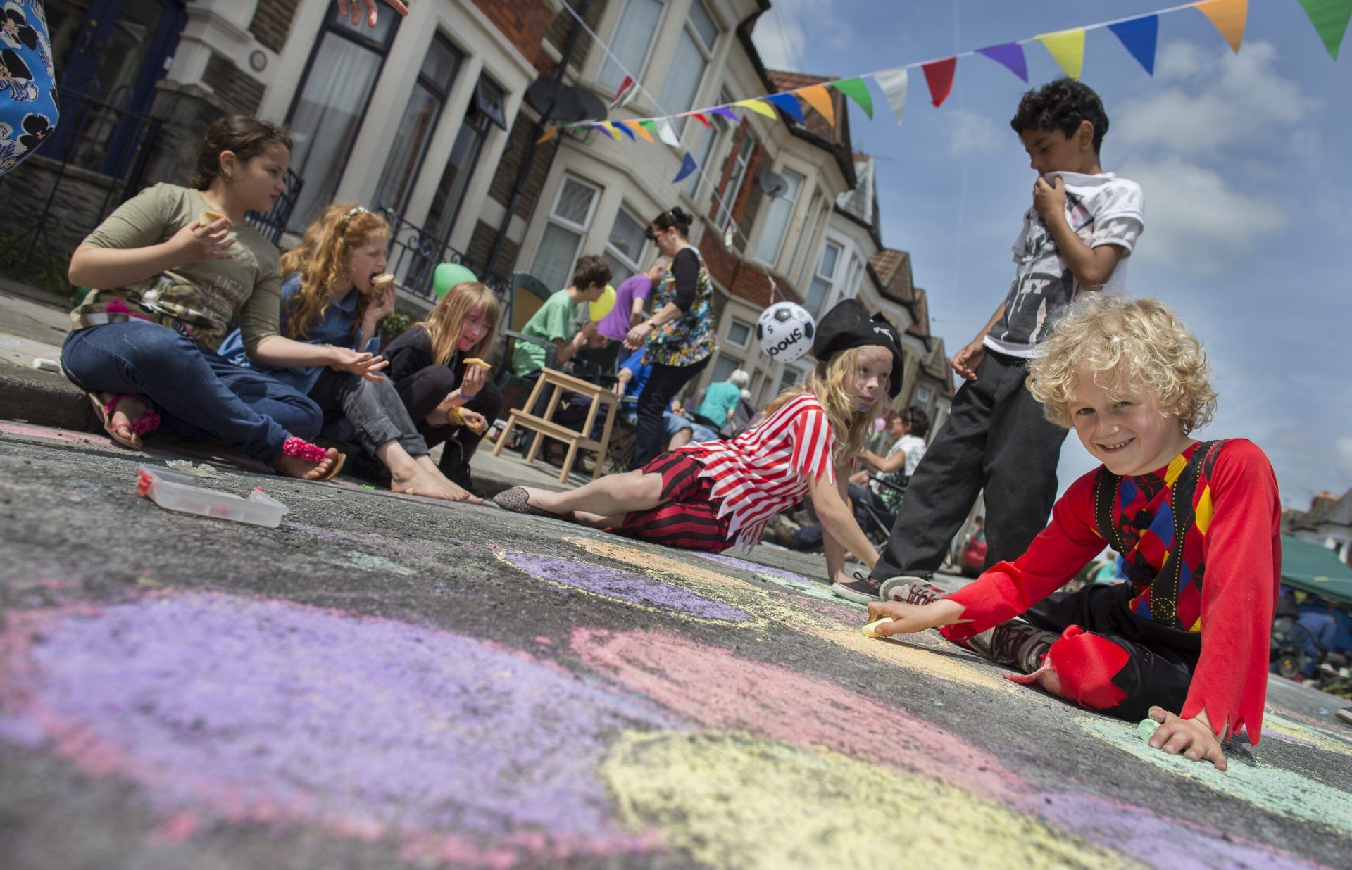 Children drawing on concrete with chalk