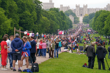 Hundreds of people on pathway leading up to castle