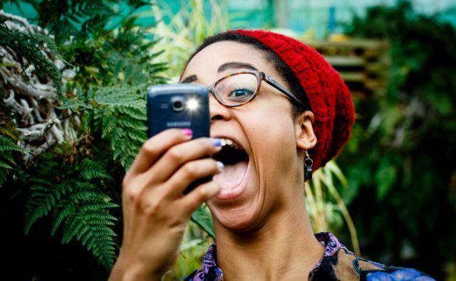 Woman taking a picture with flash