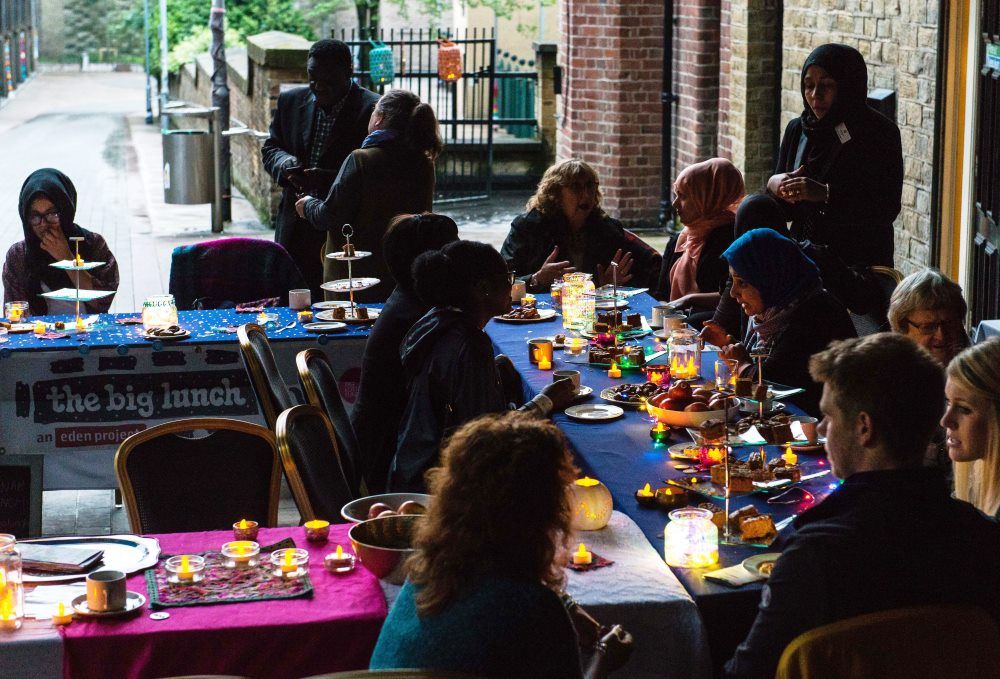 Group of people having lunch with lots of candles on tables