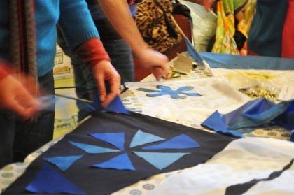 Children's hands decorating a tablecloth with an abstract pattern 