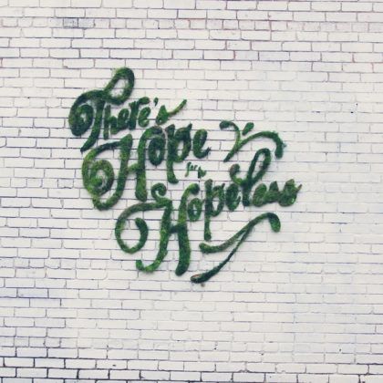 Graffiti made of moss saying "There's hope for the hopeless."