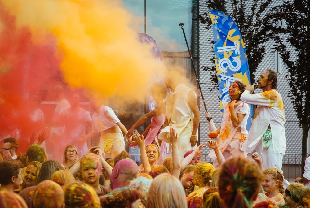 Colour bombs thrown into crowd of people covered in paint