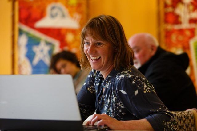 Woman smiling at her computer