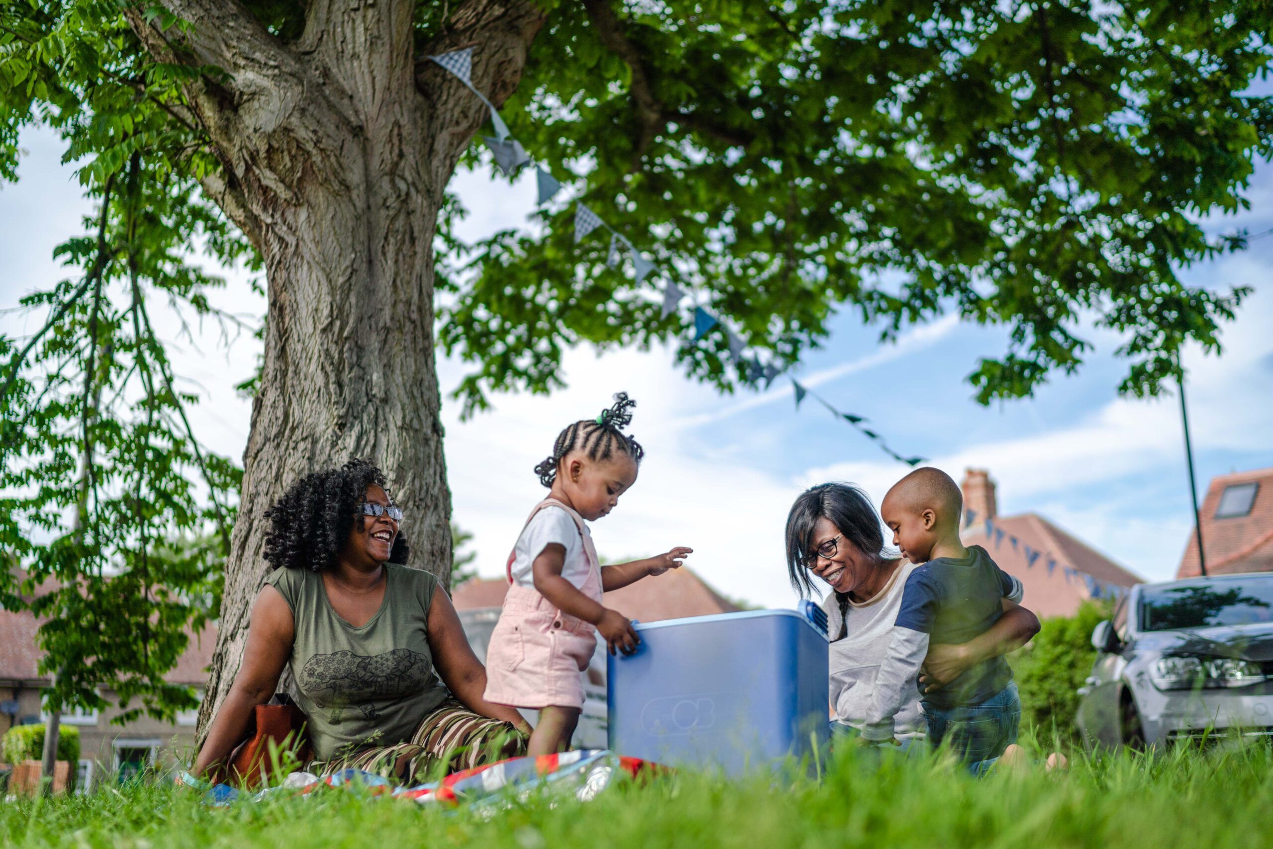 Group of people having a picnic under a tree