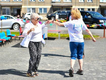 Two women dancing on the street
