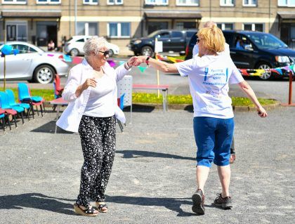 Two women dancing on the street