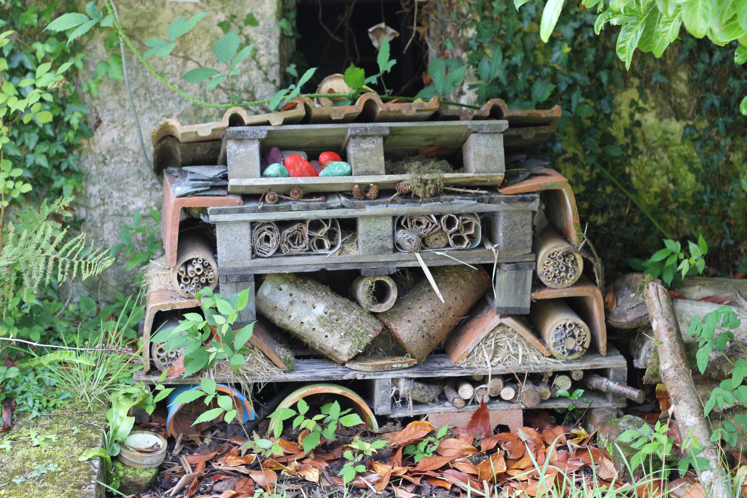 A bee hotel made from a series of pallets, bricks and other recycled materials at the Eden Project.