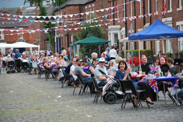 People having lunch on tables in the street