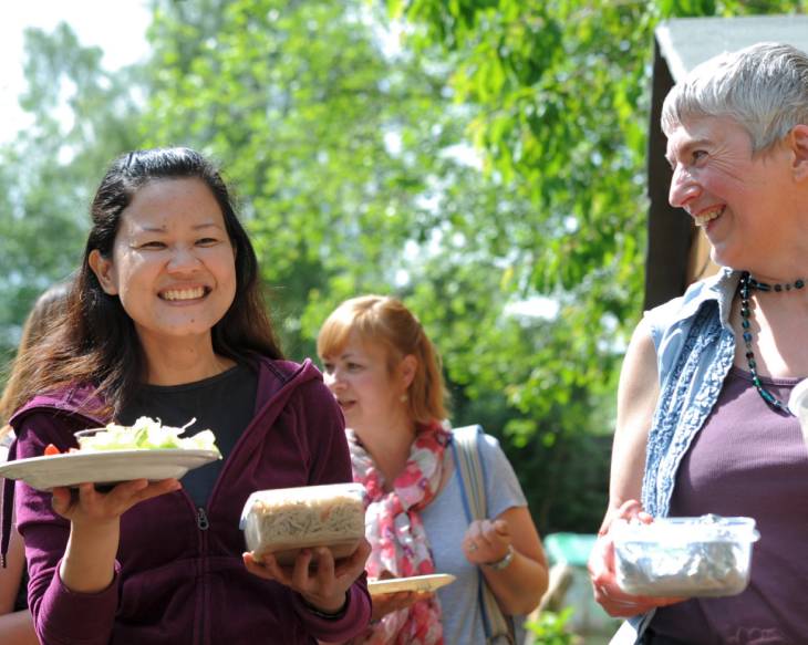 People smiling holding food