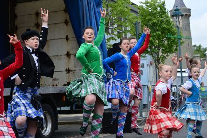 Children dancing in colourful kilts