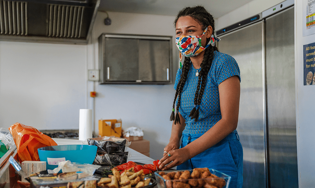 Woman cutting tomatoes in kitchen