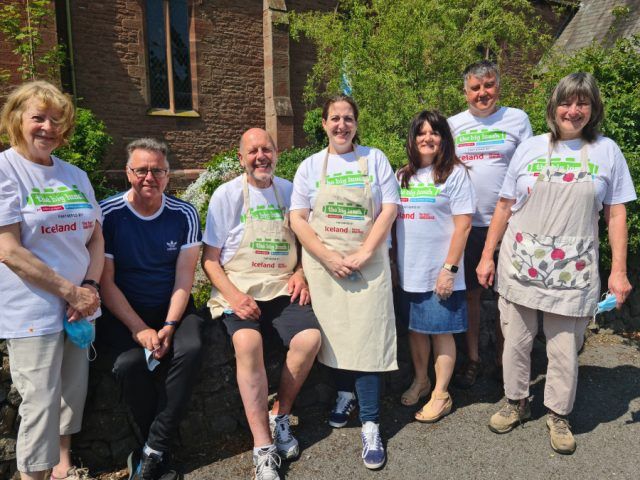 Seven volunteers posing outside for photo