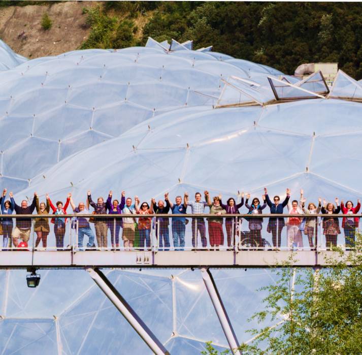 The Eden Project with a group of people standing outside on a bridge one of the family
