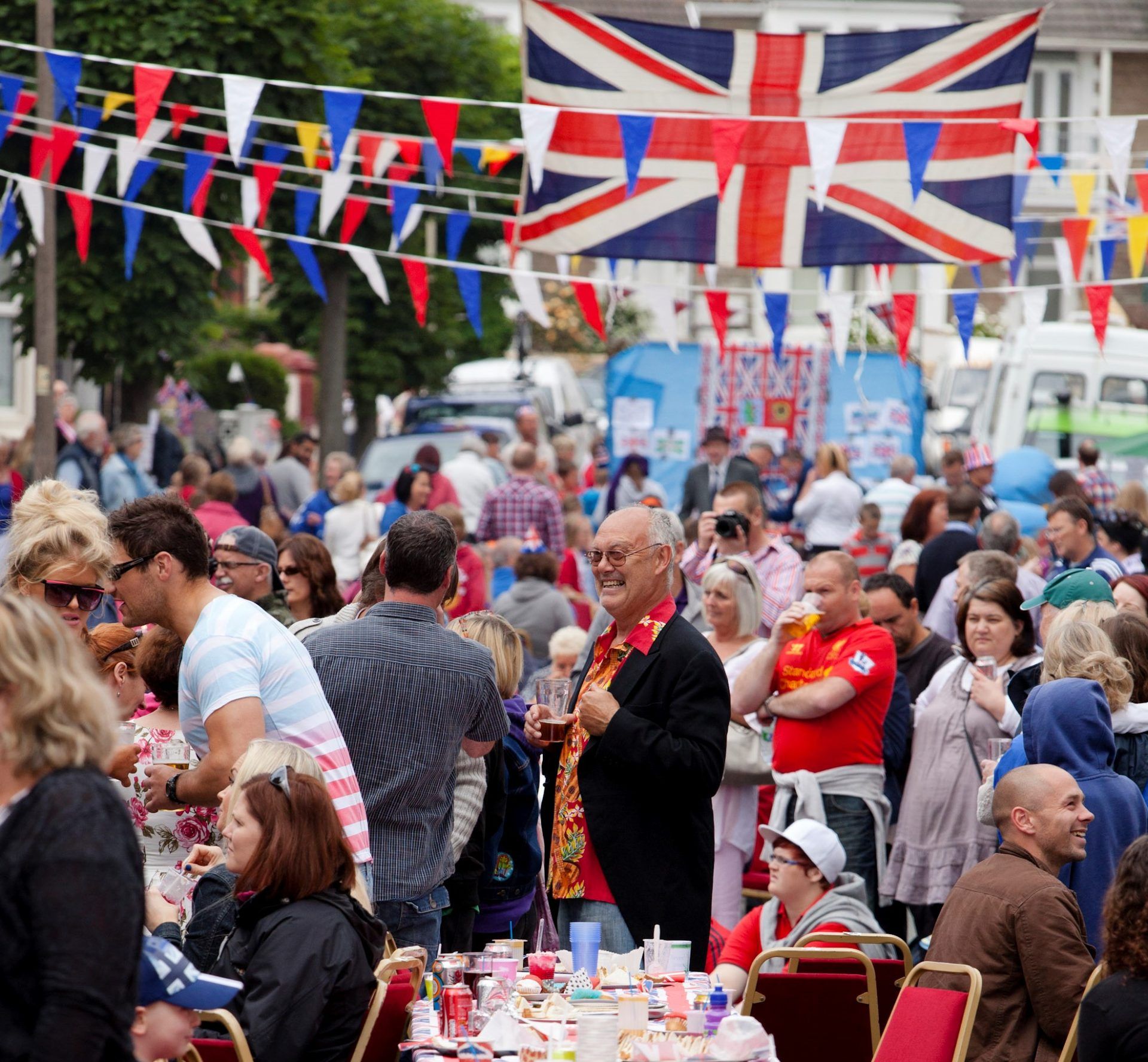 Group of people outside having lunch surrounded with British flags