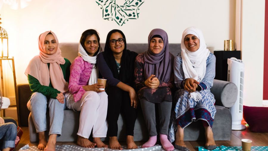 A group of women sat on a sofa