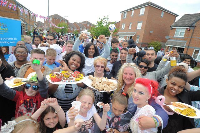 The Big Lunch in a Birmingham street, dozens of neighbours together with food platters