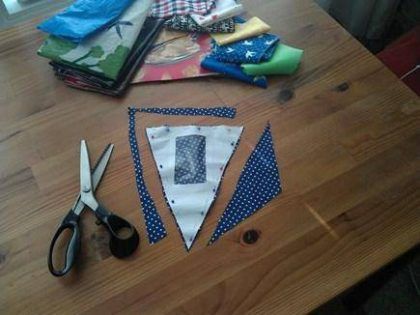 table with scissors and bunting being made