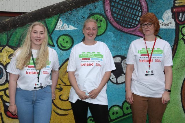 3 female members of staff wearing Big Lunch T-shirts with the Iceland logo