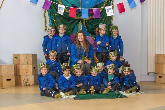 Children standing in front of their 'wild throne'