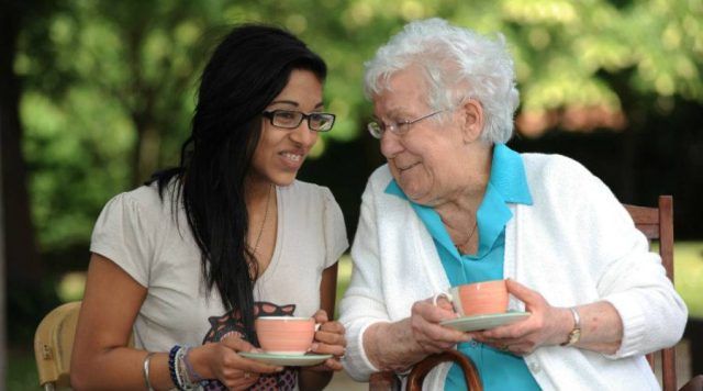 Elderly lady talking to younger girl