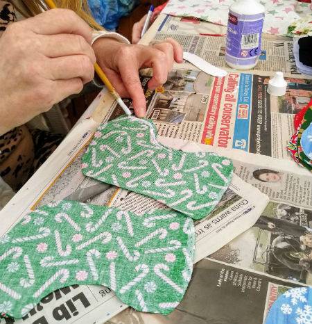 Person making christmas stockings from fabric