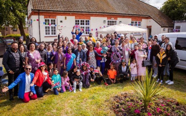 Group outside village hall smiling