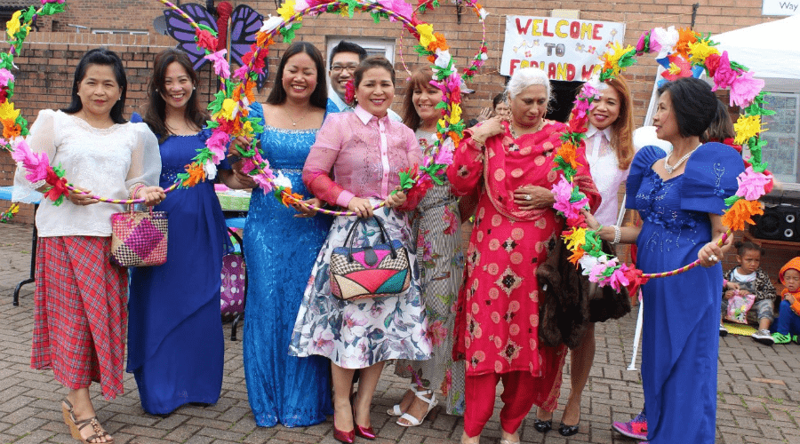 Group of women smiling with large flower rings