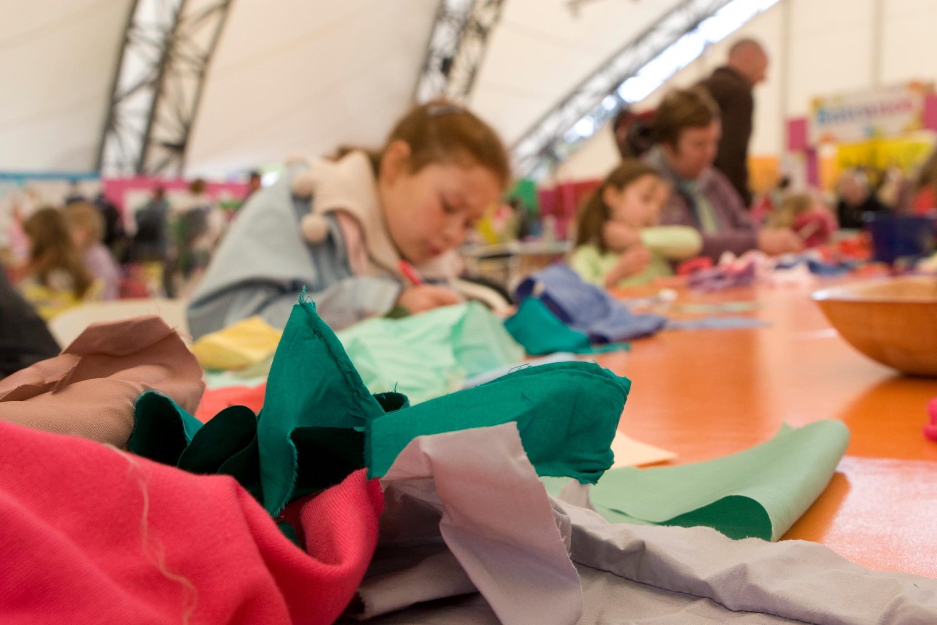 Pieces of fabric on a table ready to be made into bunting