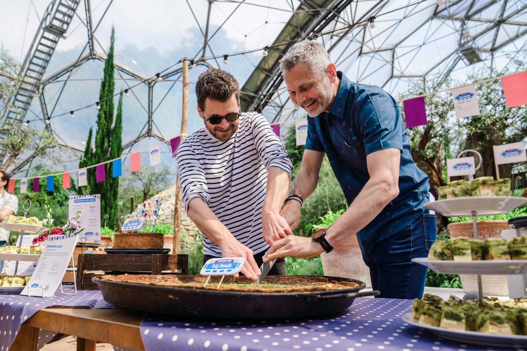 Cutting a giant Coronation Quiche in the Med Biome at the Eden Project