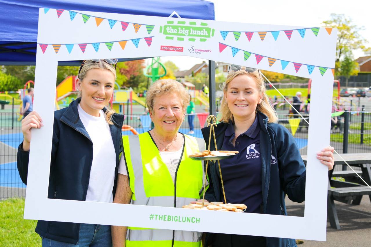 Three women smile in a Big Lunch selfie frame