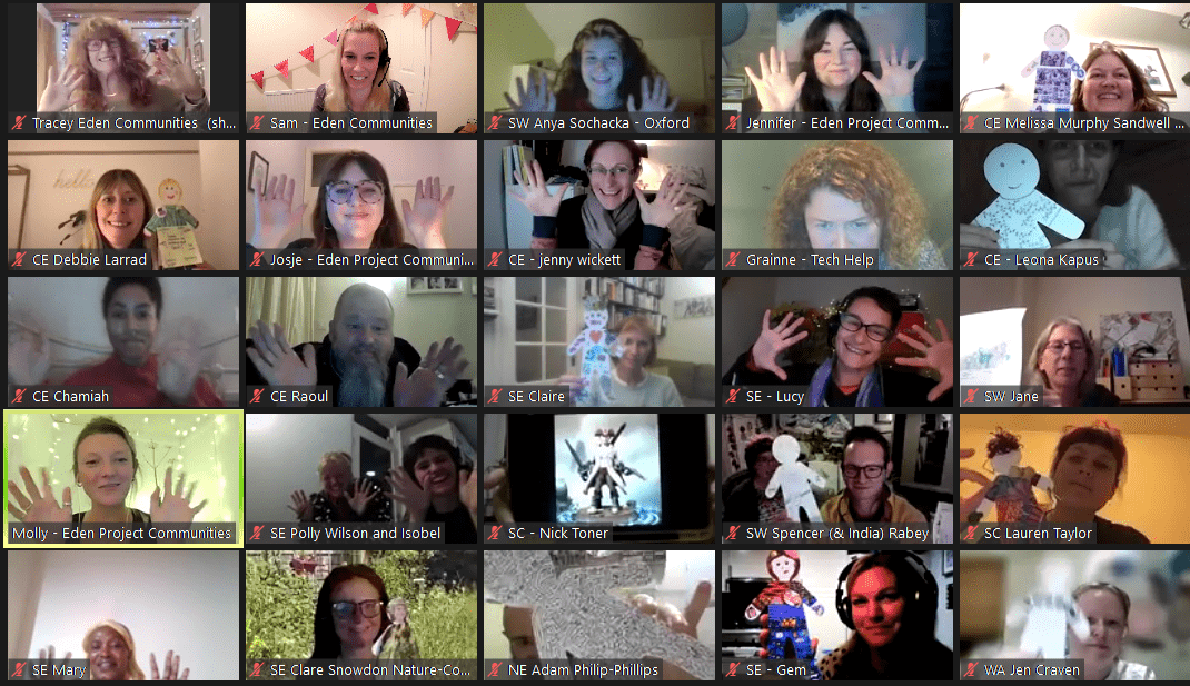 Screenshot of Zoom with 25 participants all raising their hands and smiling