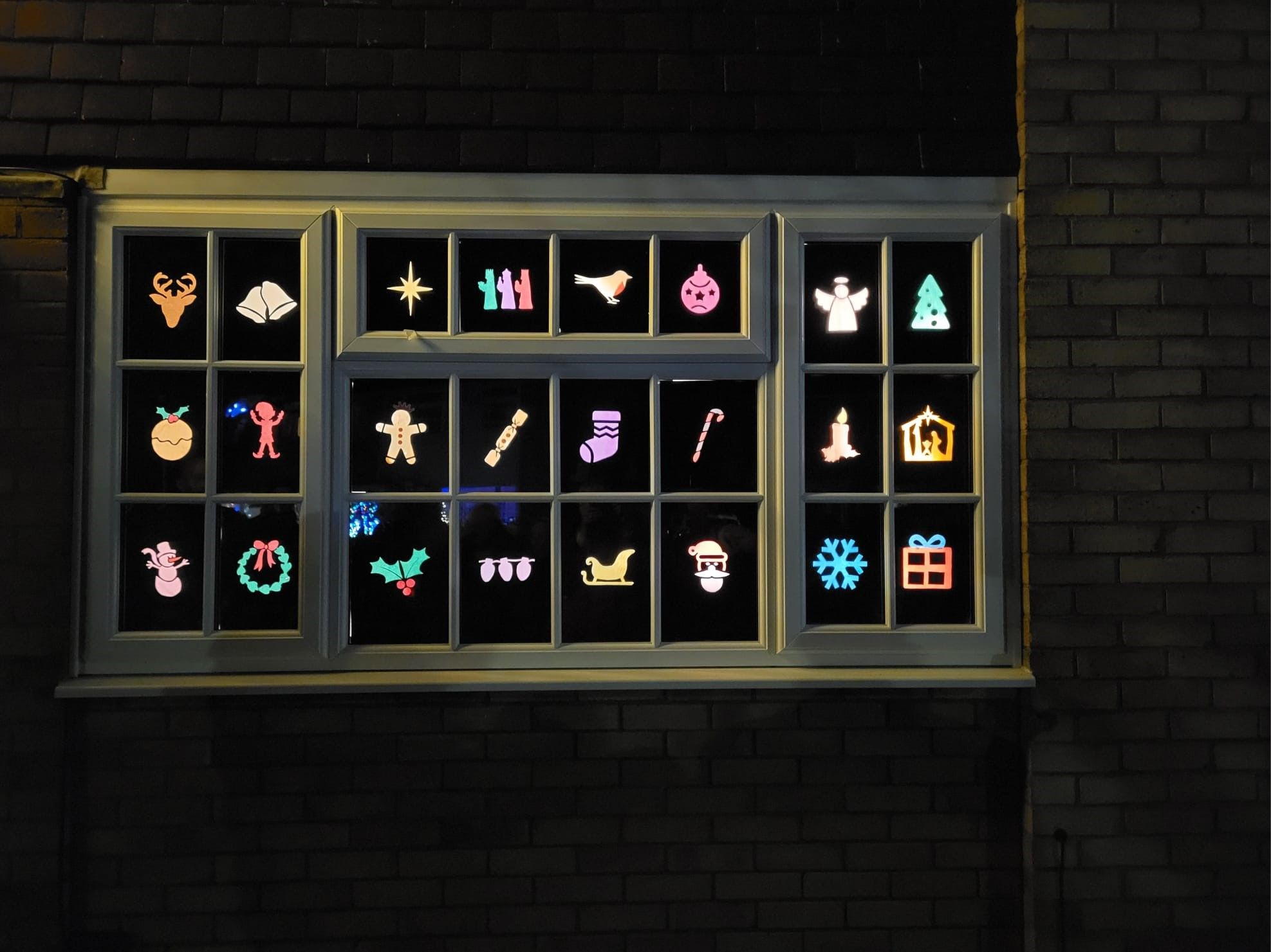 An advent window showing Christmas-themed icons in every pane, in lots of colours.