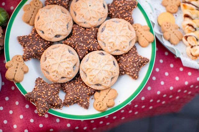 A plate of delicious-looking mince pies, chocolate biscuits and gingerbread men
