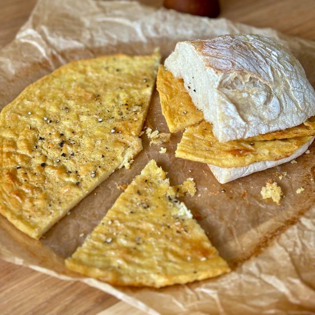 Farinata - a chickpea pancake with black pepper on top within a ciabatta roll