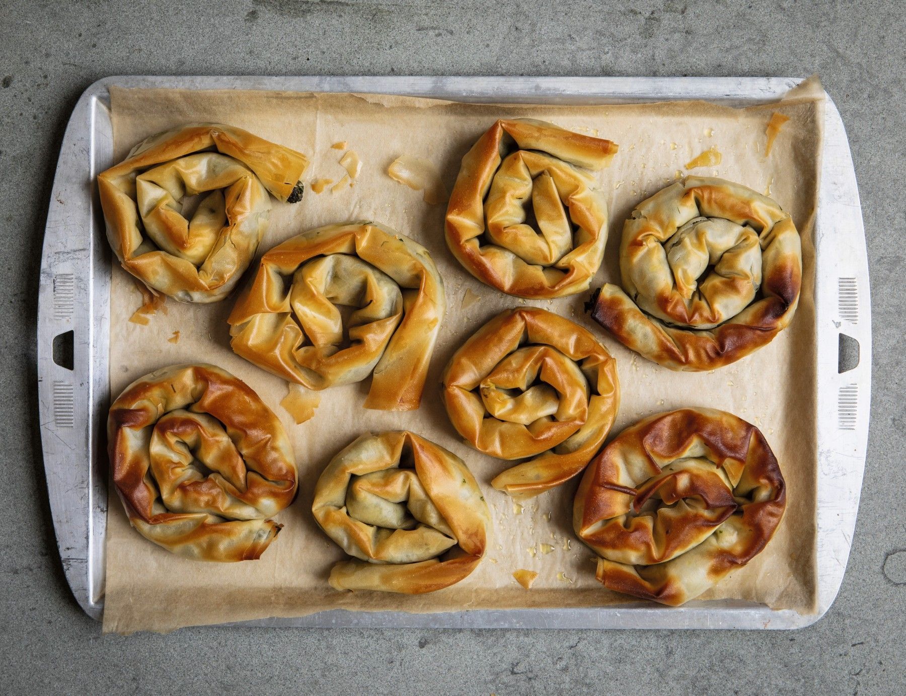 Feta and spinach swirls on a baking tray