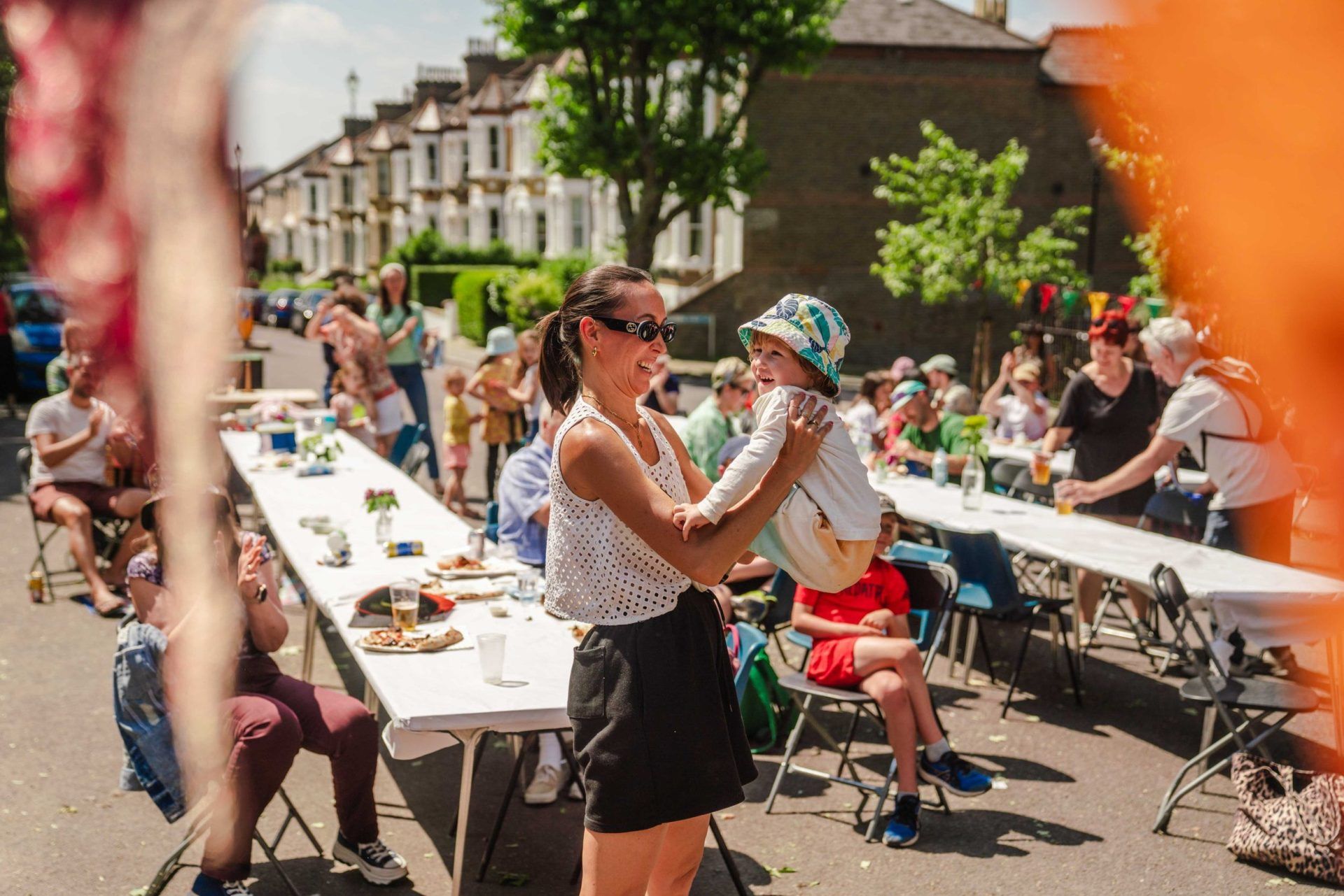 Woman dancing with her baby at a street party community Big Lunch