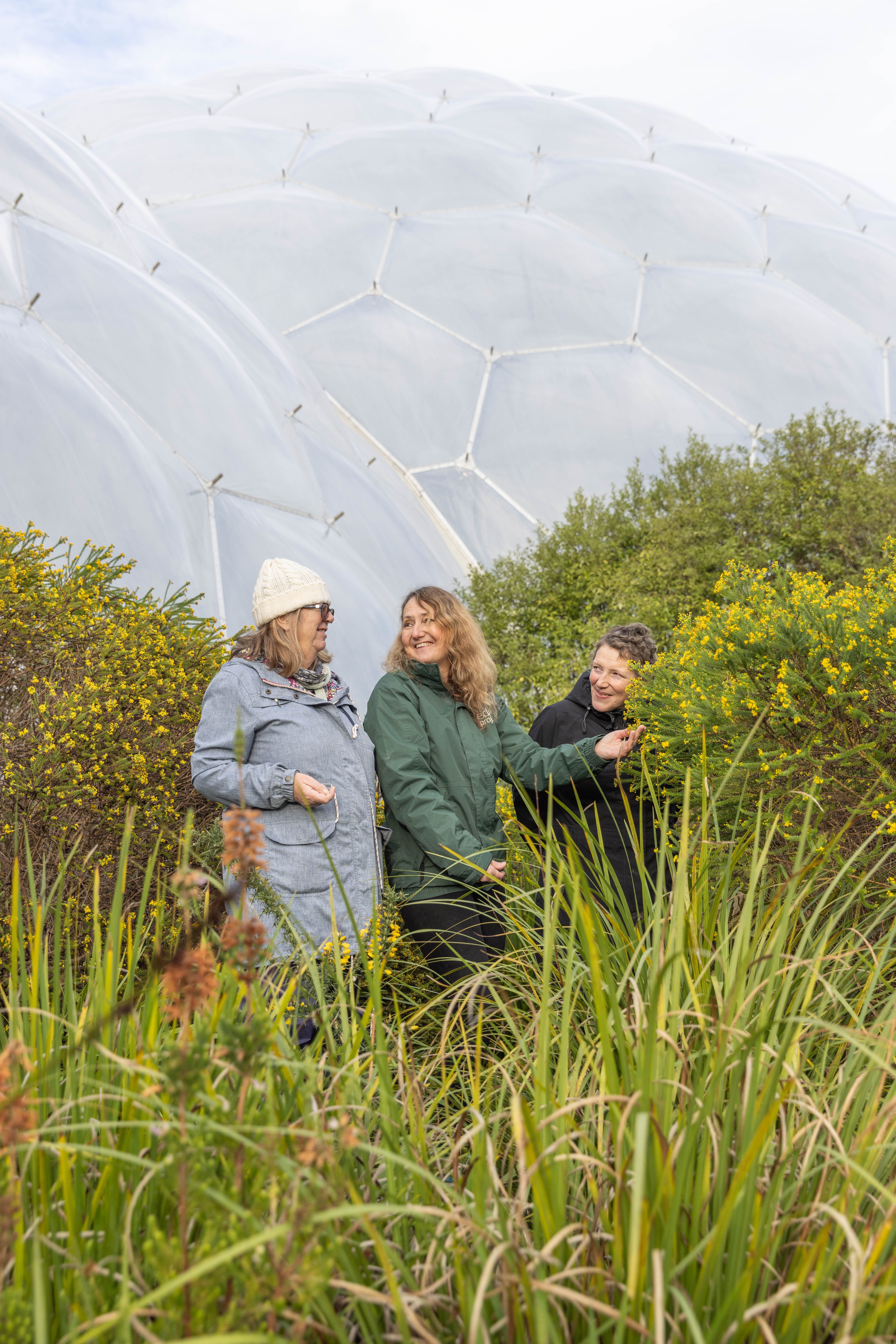 Three women in nature outside at the Eden Project