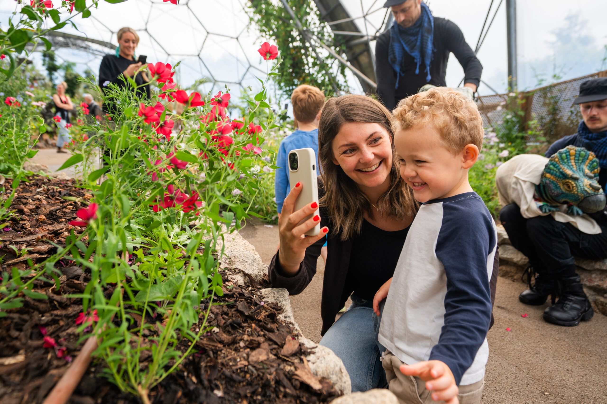 A woman and a little boy look at some plants in the Mediterranean Biome at the Eden Project